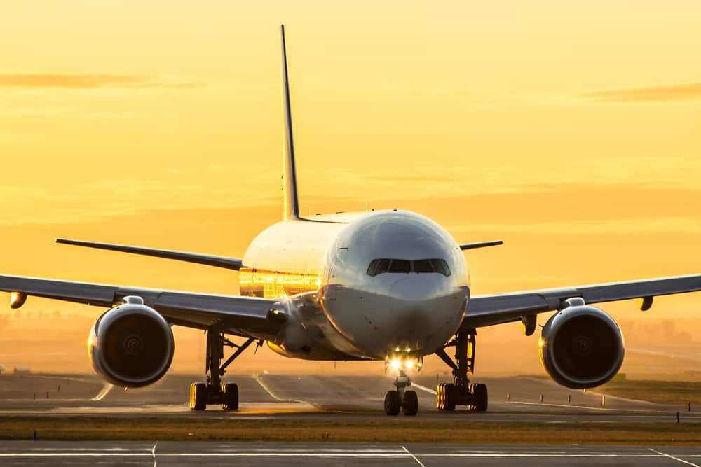 Aircraft on runway in sunset