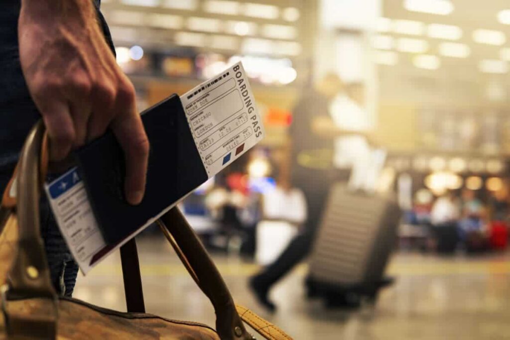 person with boarding card and passport