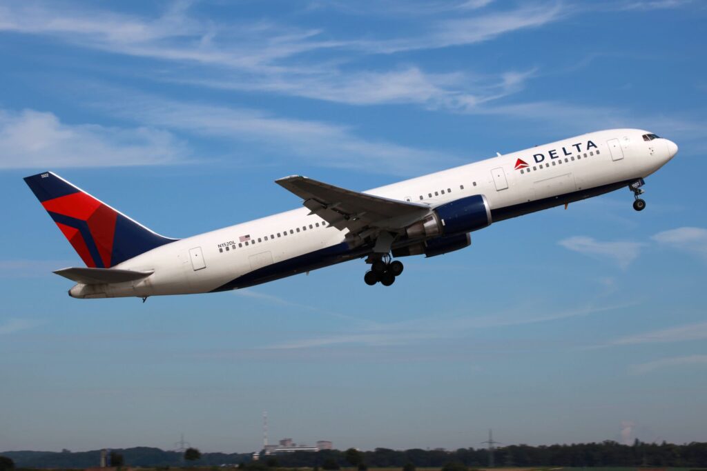 Delta airlines boeing aircraft in the air after taking off.