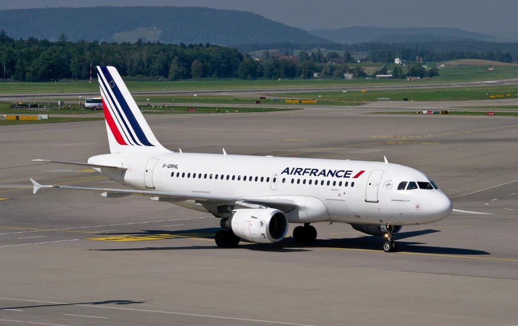 Air France airline is taxiing on an airport runway.