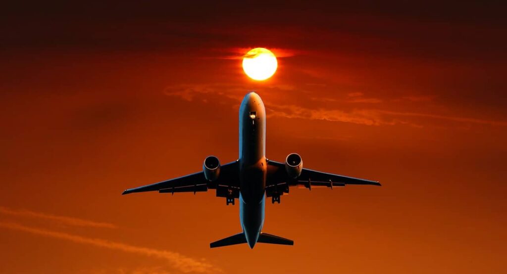 Aircraft taking off at sunset